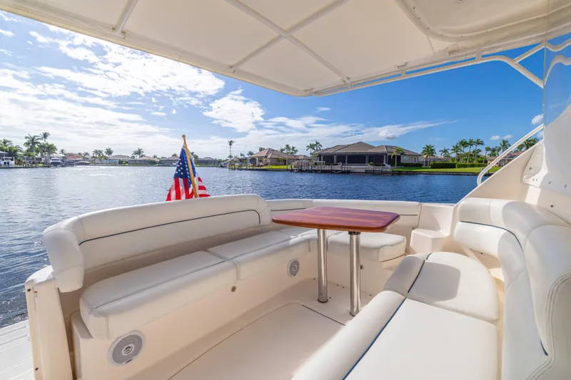 Slide: The Image of 2011 Tiara Yachts 4300 Sovran cockpit with seating, table, and waterfront view. - 13