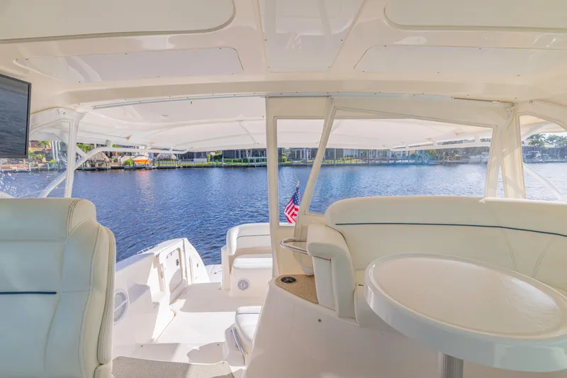 Slide: The Image of Interior view of 2011 Tiara Yachts 4300 Sovran, featuring luxurious seating and waterfront backdrop. - 15