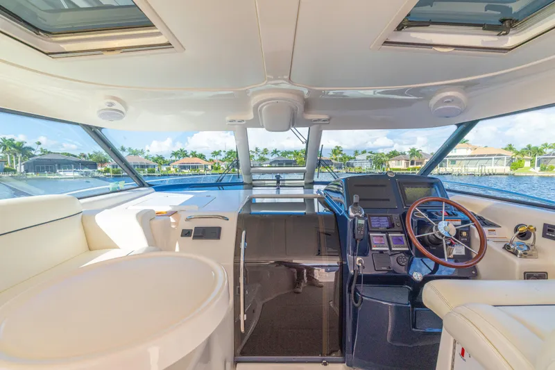 Slide: The Image of Interior view of 2011 Tiara Yachts 4300 Sovran, featuring helm and luxurious seating. - 16