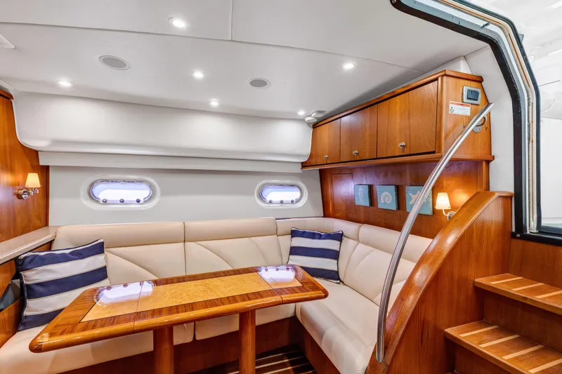 Slide: The Image of Luxurious interior of 2011 Tiara Yachts 4300 Sovran with elegant seating and wooden accents. - 18