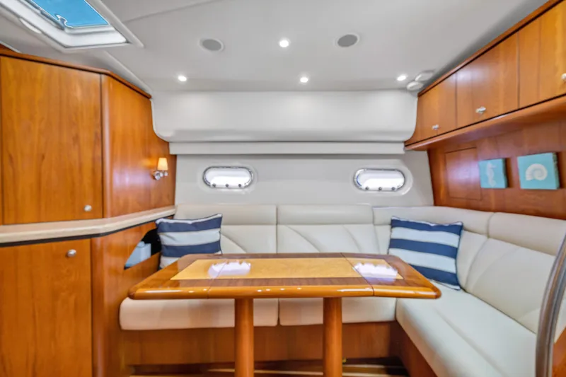 Slide: The Image of Luxurious interior of 2011 Tiara Yachts 4300 Sovran with elegant seating and wooden cabinetry. - 24