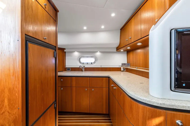 Slide: The Image of Luxurious 2011 Tiara Yachts 4300 Sovran kitchen with wood cabinetry and modern appliances. - 25