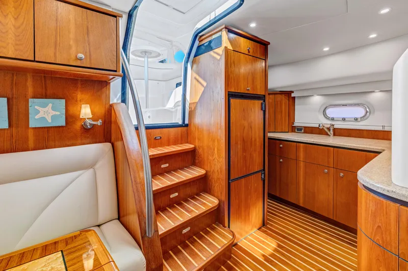 Slide: The Image of Luxurious interior of 2011 Tiara Yachts 4300 Sovran with wooden cabinetry and modern kitchen. - 27