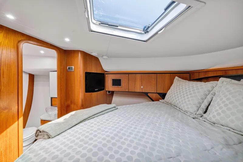 Slide: The Image of Luxurious cabin interior of 2011 Tiara Yachts 4300 Sovran with skylight and cozy bedding. - 30