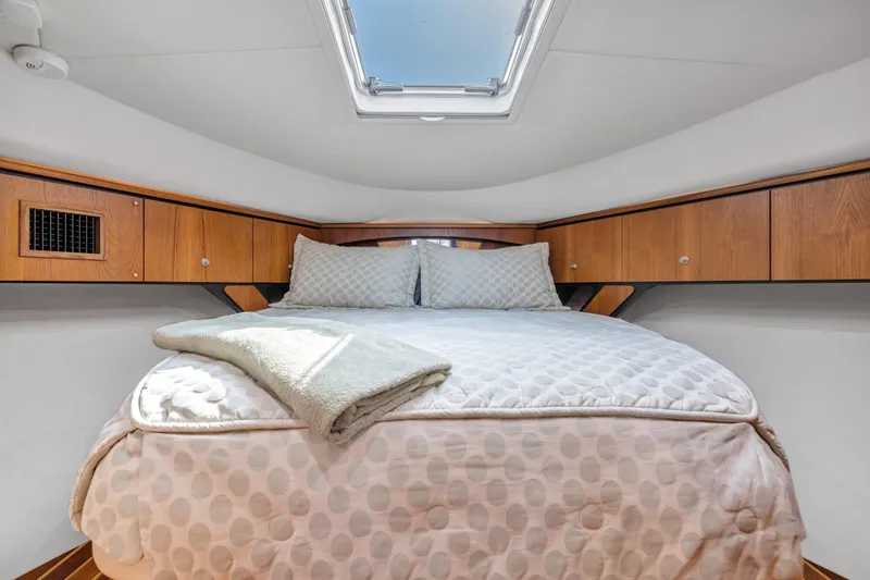 Slide: The Image of Cozy bedroom in 2011 Tiara Yachts 4300 Sovran with skylight and wooden cabinets. - 31