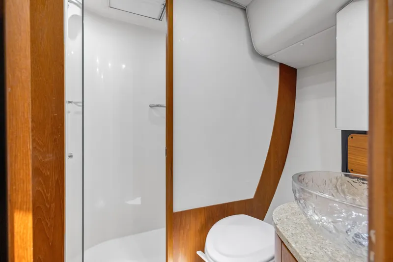 Slide: The Image of Luxurious bathroom in 2011 Tiara Yachts 4300 Sovran with modern fixtures and glass sink. - 32
