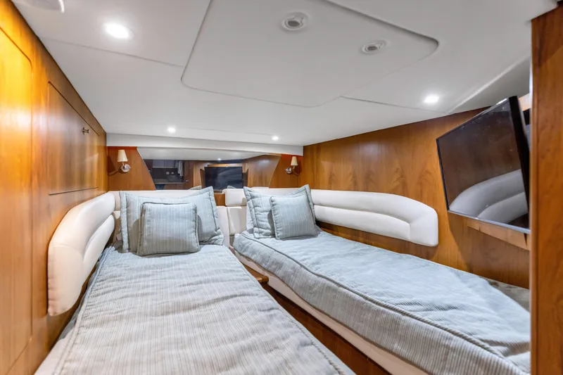 Slide: The Image of Luxurious cabin interior of 2011 Tiara Yachts 4300 Sovran with twin beds and modern amenities. - 33