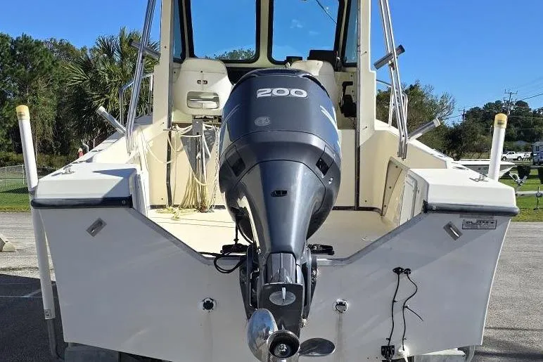 Slide: The Image of 2000 Maycraft Pilot House 2300 boat with powerful 200 HP outboard motor. - 2