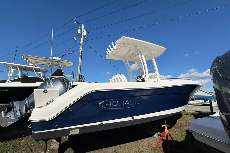 The Image of 2021 Robalo R222 Explorer boat with Yamaha engine, parked outdoors under clear blue sky. - 1