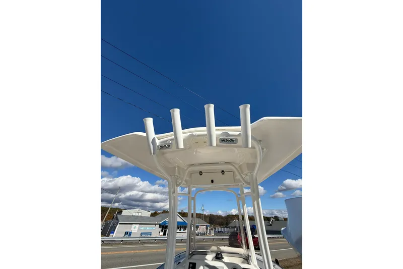 Slide: The Image of 2021 Robalo R222 Explorer boat with T-top and rod holders under clear blue sky. - 14