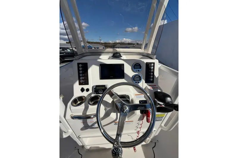 Slide: The Image of 2021 Robalo R222 Explorer boat dashboard with steering wheel and control panel. - 6