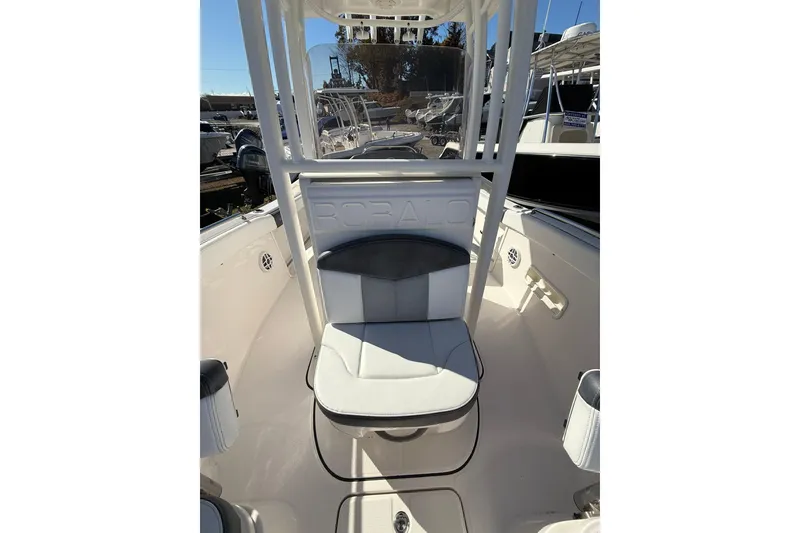 Slide: The Image of 2021 Robalo R222 Explorer boat interior with seating and console view. - 8
