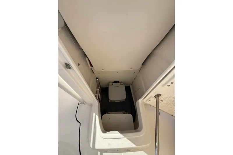 Slide: The Image of 2021 Robalo R222 Explorer boat interior with compact toilet compartment. - 9