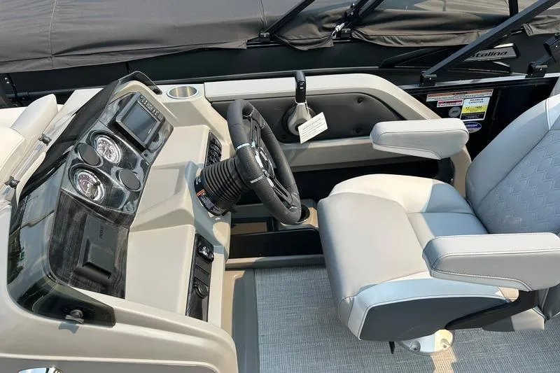 Slide: The Image of 2025 Avalon LSZ REAR LOUNGER boat interior with steering console and comfortable seating. - 5