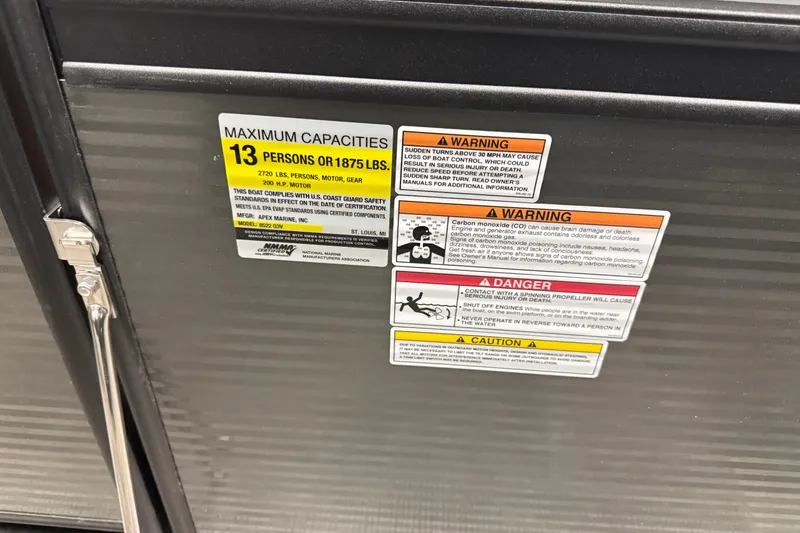 Slide: The Image of 2026 Qwest M-Class 22 Pro Sport capacity and safety warning labels on boat panel. - 20