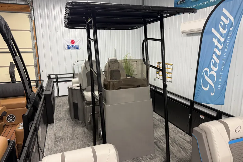 Slide: The Image of 2026 Qwest M-Class 22 Pro Sport boat interior with seating and canopy in showroom. - 4
