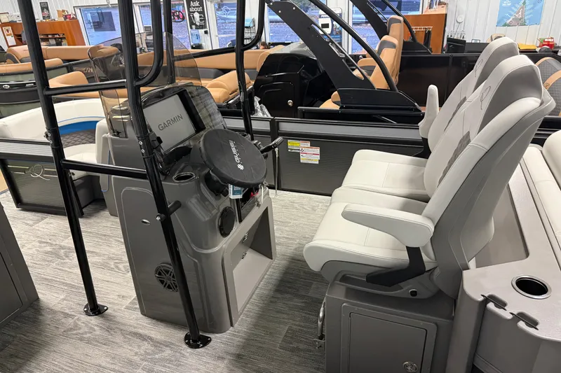 Slide: The Image of Interior of 2026 Qwest M-Class 22 Pro Sport boat with modern seating and Garmin equipment. - 6