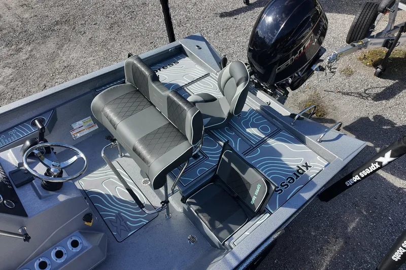 Slide: The Image of 2026 Xpress H22B Bay boat interior with modern seating and steering wheel. - 12