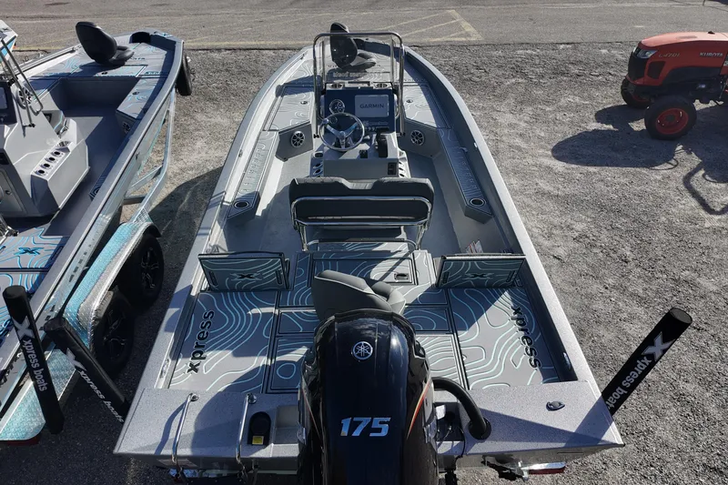 Slide: The Image of 2026 Xpress H22B Bay boat with Yamaha 175 engine, parked on gravel. - 13