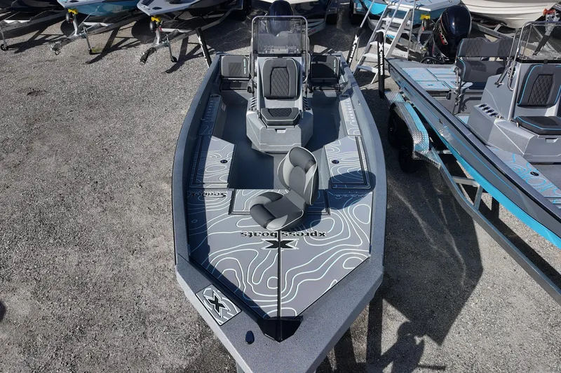 Slide: The Image of 2026 Xpress H22B Bay boat with sleek design and modern seating, displayed outdoors. - 14