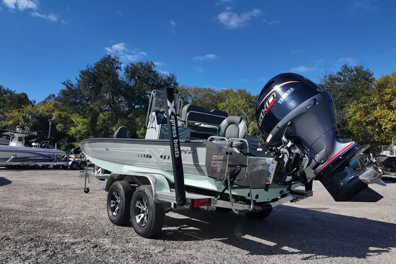 Slide: The Image of 2026 Xpress H22B Bay boat with Yamaha engine on trailer, parked outdoors. - 4