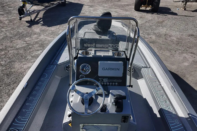 Slide: The Image of 2026 Xpress H22B Bay boat interior with Garmin navigation system and steering console. - 7