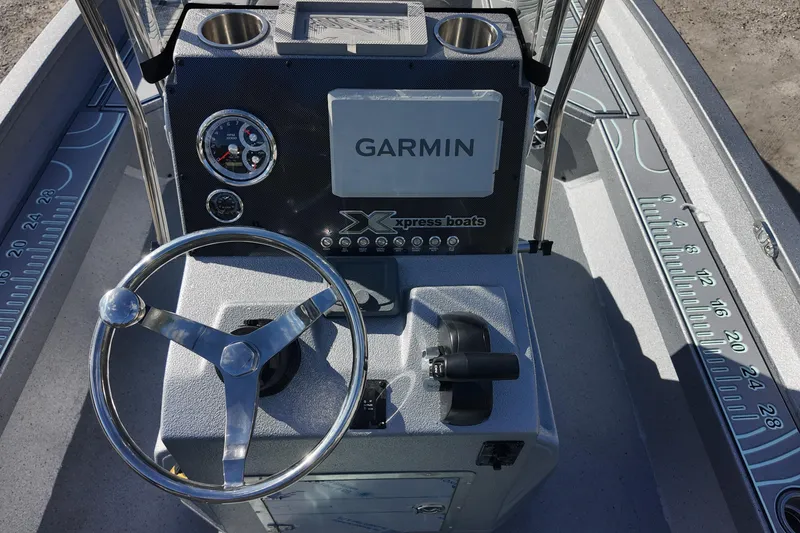 Slide: The Image of 2026 Xpress H22B Bay boat dashboard with Garmin display and steering wheel. - 8