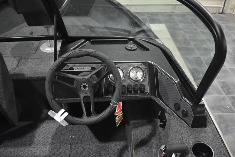 Slide: The Image of 2026 Lund 1650 Rebel XL Sport boat dashboard with steering wheel and gauges. - 10