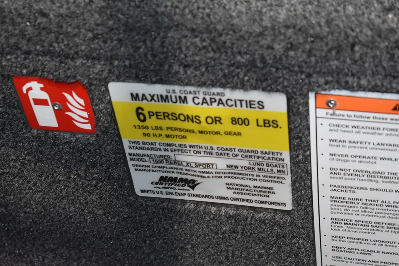 Slide: The Image of U.S. Coast Guard capacity label on 2026 Lund 1650 Rebel XL Sport boat, 6 persons or 800 lbs. - 11