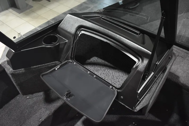Slide: The Image of 2026 Lund 1650 Rebel XL Sport boat interior storage compartment with open hatch. - 13
