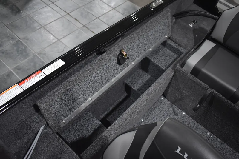 Slide: The Image of 2026 Lund 1650 Rebel XL Sport interior storage compartments and seating detail. - 14