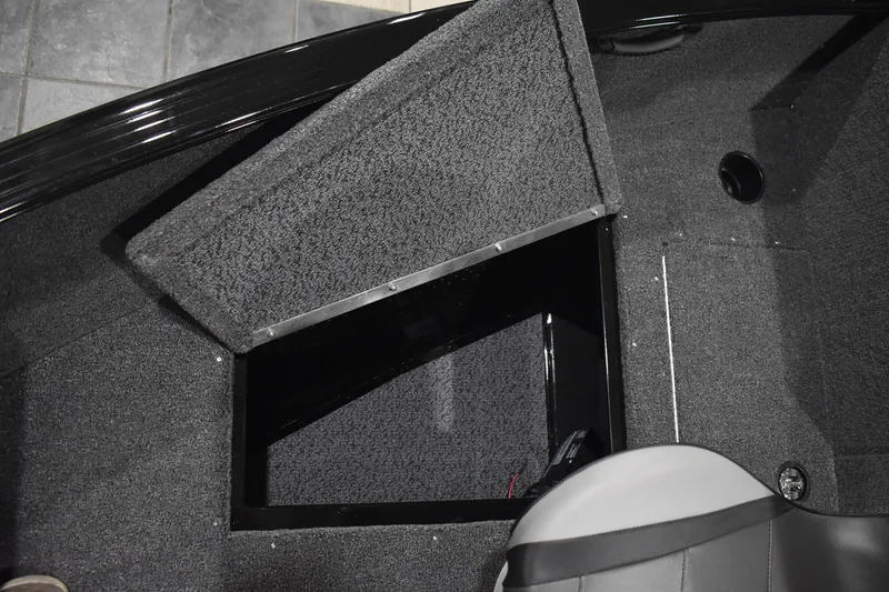Slide: The Image of 2026 Lund 1650 Rebel XL Sport boat interior storage compartment with open hatch. - 22