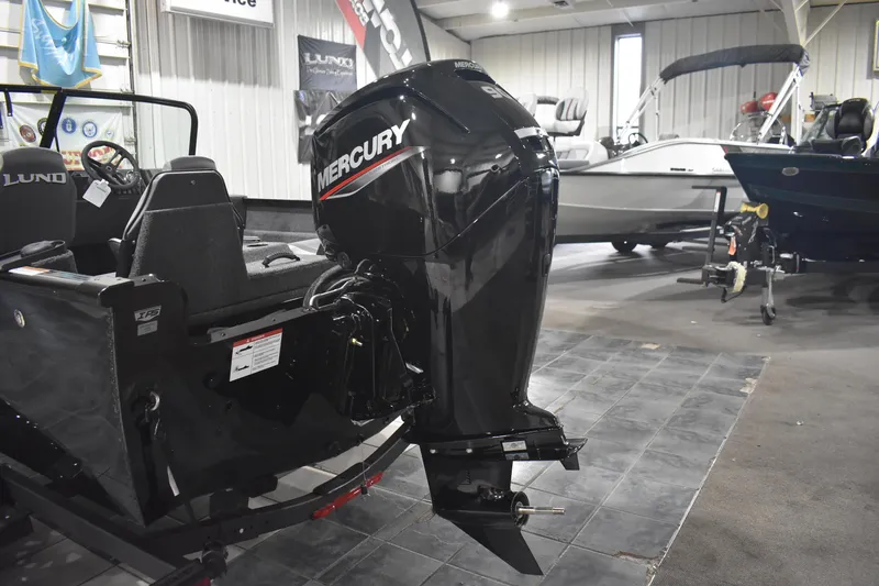 Slide: The Image of 2026 Lund 1650 Rebel XL Sport boat with Mercury outboard motor in showroom. - 7