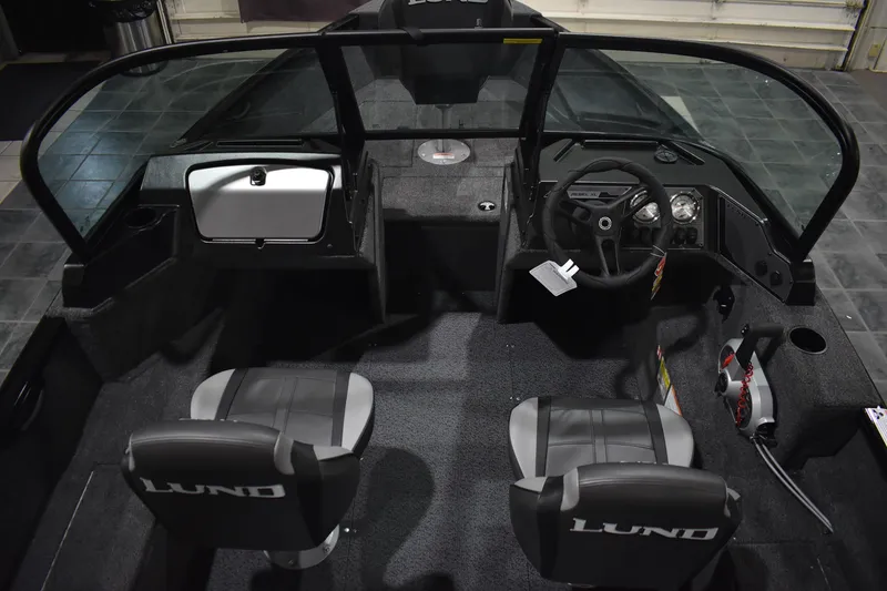 Slide: The Image of 2026 Lund 1650 Rebel XL Sport boat interior with dual seats and steering console. - 8