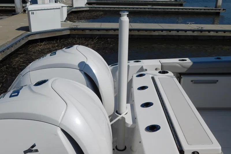 Slide: The Image of 2024 Pursuit DC 326 Dual Console boat with twin engines at dock. - 100