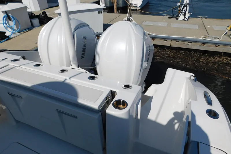 Slide: The Image of 2024 Pursuit DC 326 Dual Console with twin Yamaha outboard engines at dock. - 13