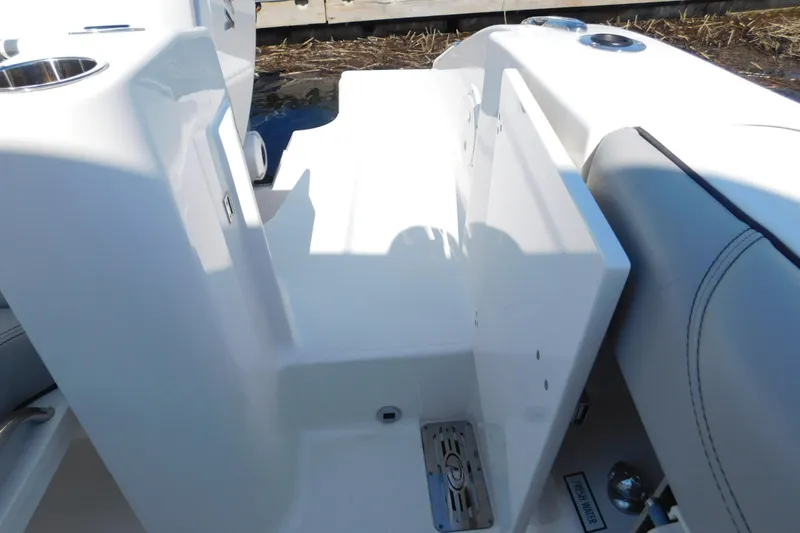 Slide: The Image of 2024 Pursuit DC 326 Dual Console boat interior with seating and storage features. - 14