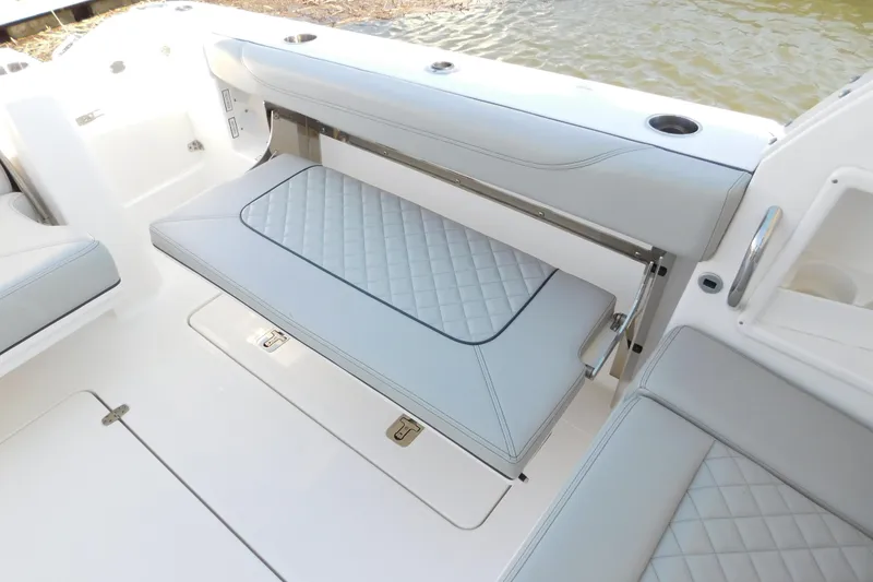 Slide: The Image of 2024 Pursuit DC 326 Dual Console boat with elegant quilted seating design. - 18