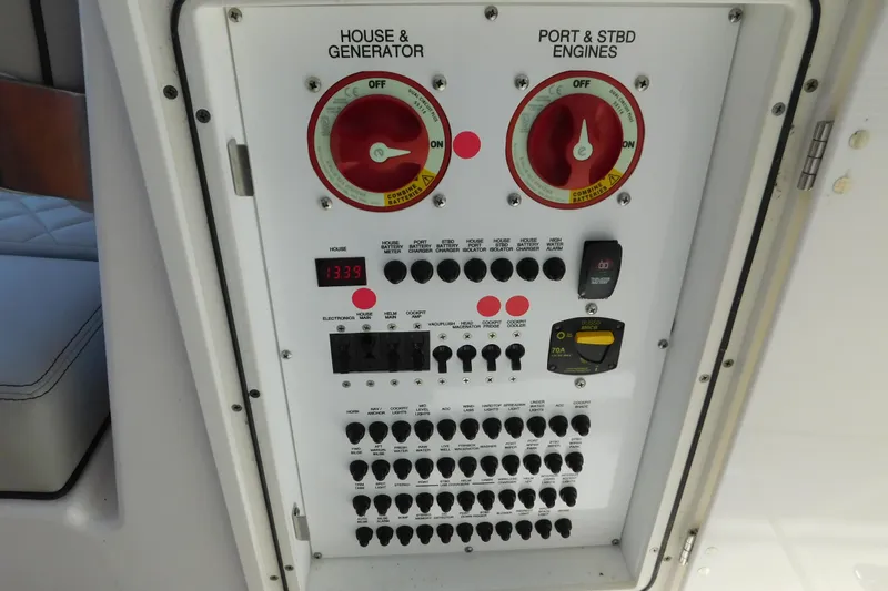 Slide: The Image of Control panel of 2024 Pursuit DC 326 Dual Console boat, featuring switches and gauges. - 21