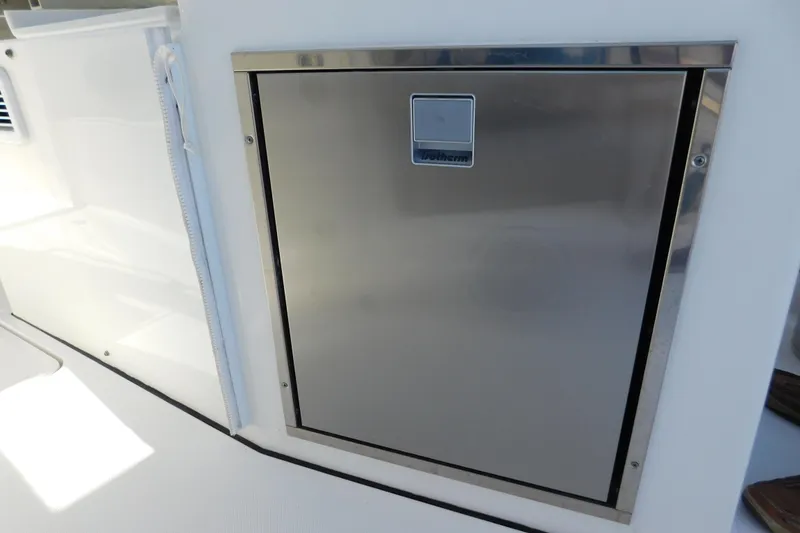 Slide: The Image of Stainless steel door on 2024 Pursuit DC 326 Dual Console boat. - 24