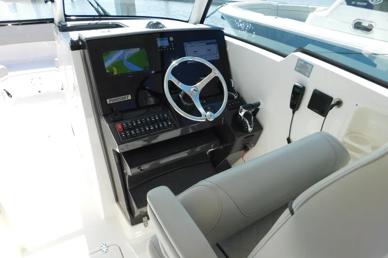 Slide: The Image of 2024 Pursuit DC 326 Dual Console helm with modern navigation system and controls. - 29