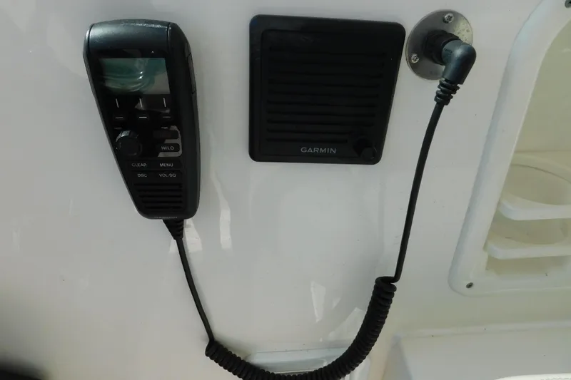 Slide: The Image of 2024 Pursuit DC 326 Dual Console boat communication system with Garmin speaker and handheld device. - 34