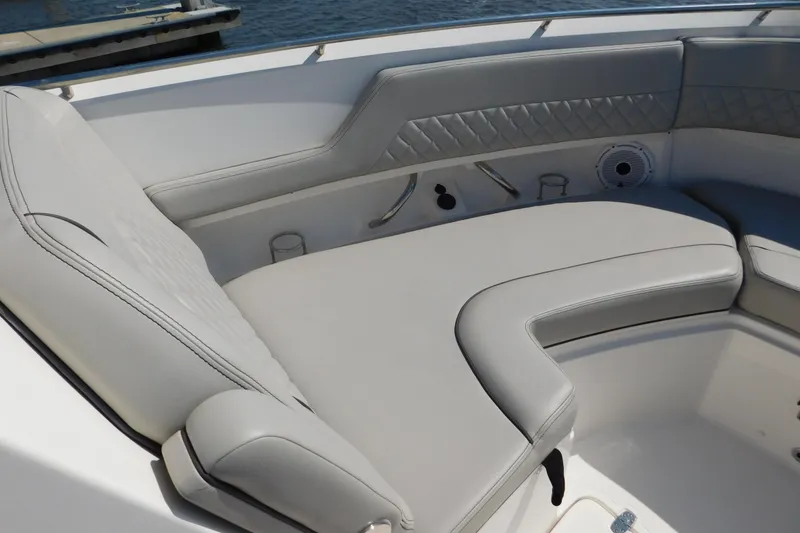 Slide: The Image of 2024 Pursuit DC 326 Dual Console boat with luxurious seating and cup holders. - 49