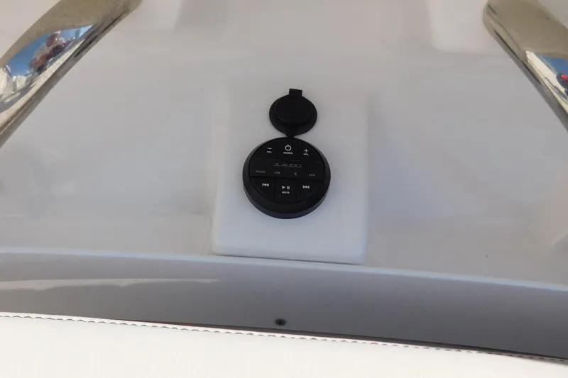 Slide: The Image of 2024 Pursuit DC 326 Dual Console audio control panel on boat dashboard. - 51