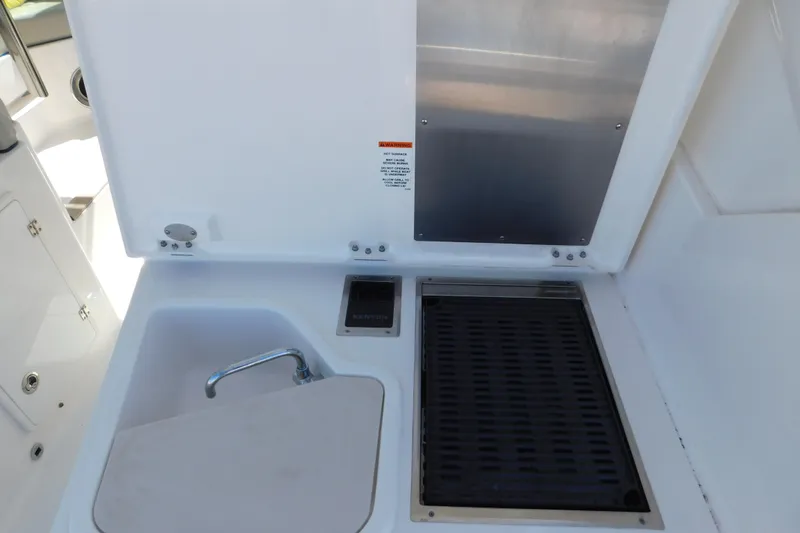 Slide: The Image of 2024 Pursuit DC 326 Dual Console boat sink and grill area. - 70