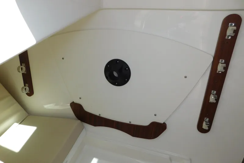 Slide: The Image of 2024 Pursuit DC 326 Dual Console interior detail with mounting brackets and panel. - 75