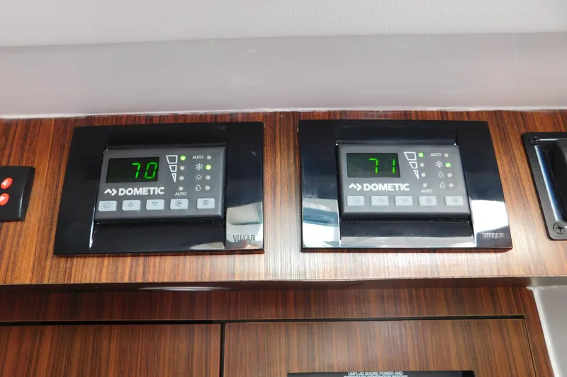 Slide: The Image of Dometic control panels on 2024 Pursuit DC 326 Dual Console, displaying temperatures 70 and 71. - 78