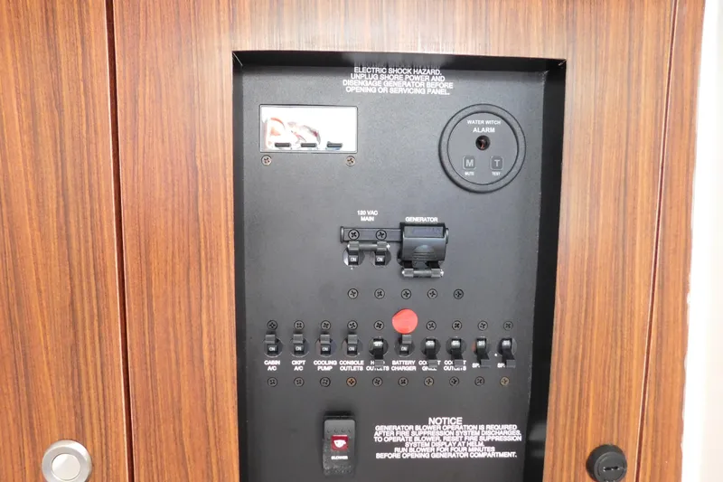 Slide: The Image of Control panel of 2024 Pursuit DC 326 Dual Console boat with switches and water alarm. - 79