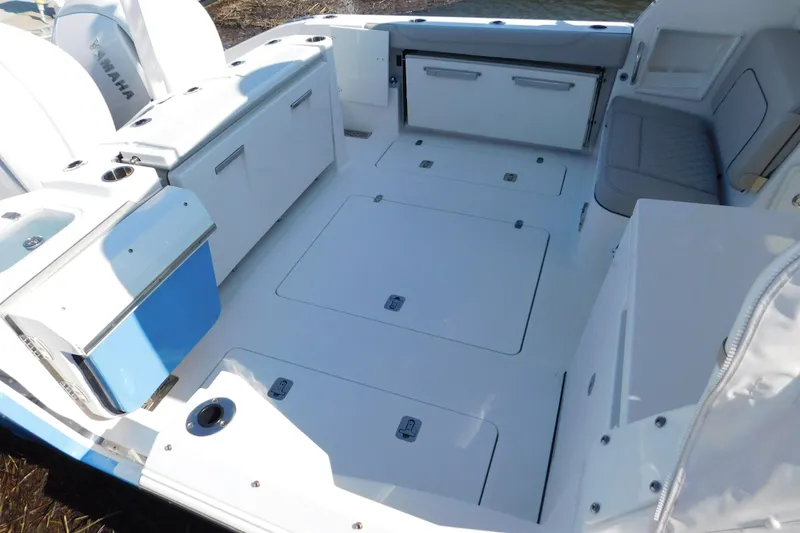 Slide: The Image of 2024 Pursuit DC 326 Dual Console boat interior with spacious deck and seating area. - 8