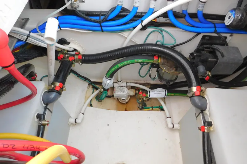 Slide: The Image of 2024 Pursuit DC 326 Dual Console boat wiring and plumbing system close-up. - 83